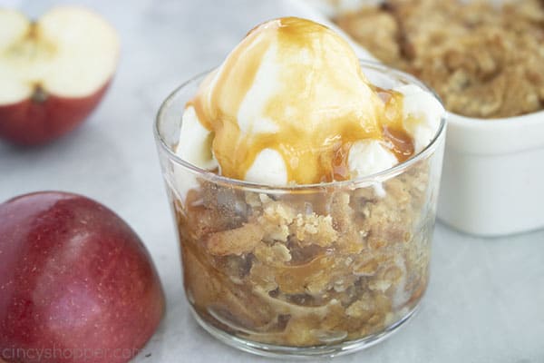 Aif Fried apple crisp in a dish with vanilla ice cream and caramel.