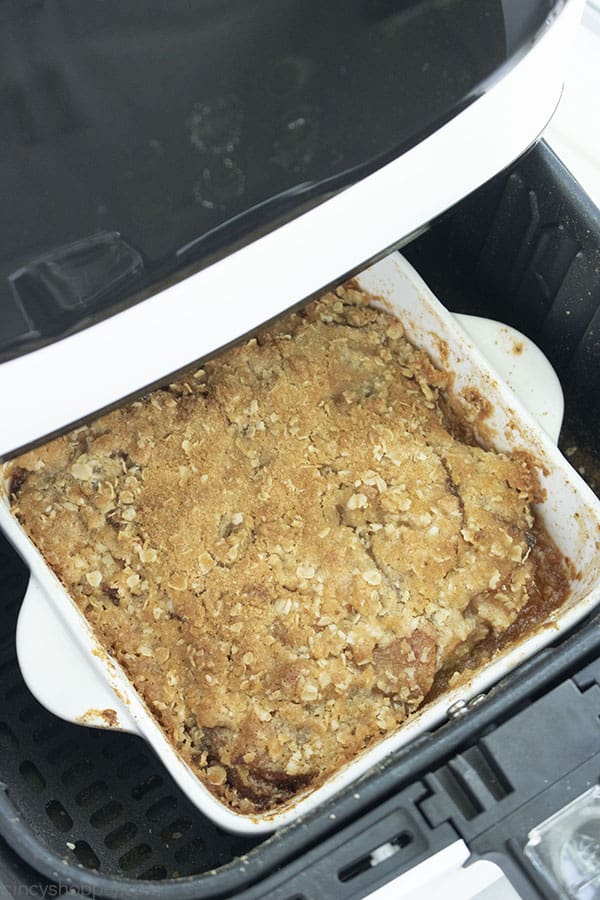 Apple Crisp in a dish placed inside of an air fryer 