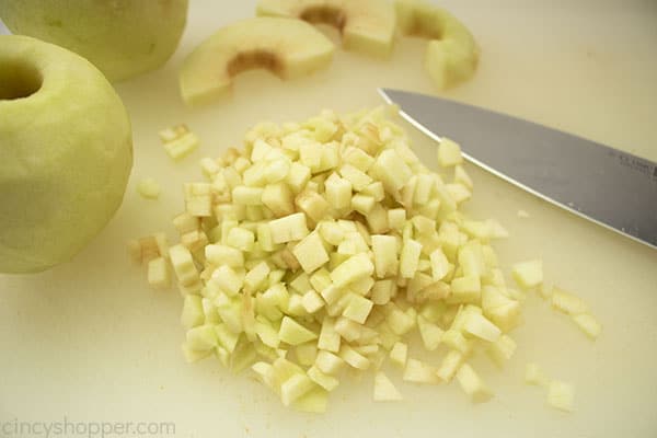 Diced apples on cutting board for cake.