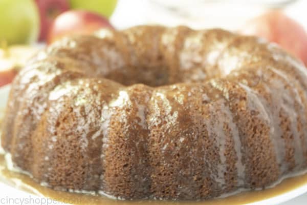 Glazed apple cake on a white plate.