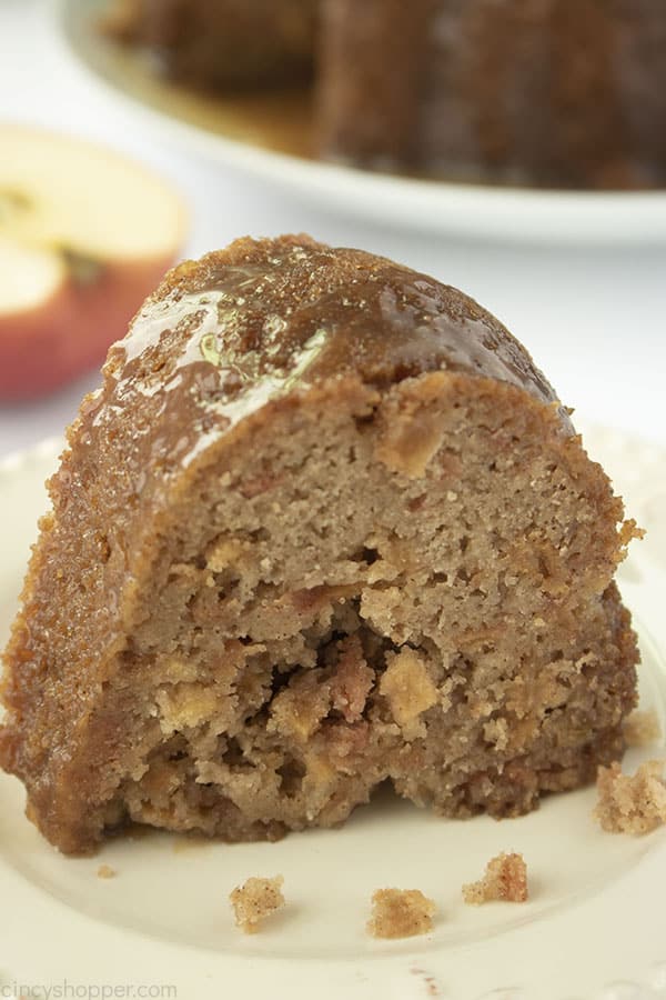 Slice of apple cake on a white plate.