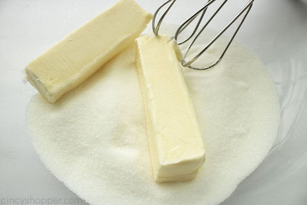 Butter and sugar added to clear mixing bowl with beaters.