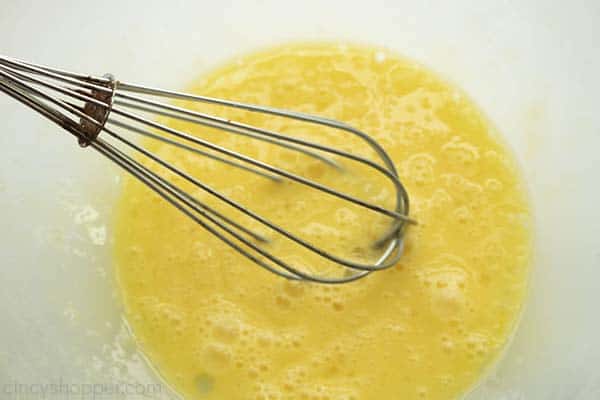 Eggs with whisk in a bowl