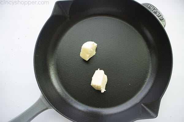 Butter pats in a skillet.