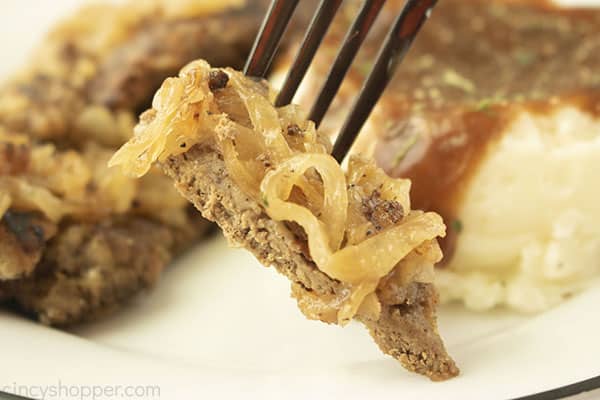 Piece of liver and onions on a fork