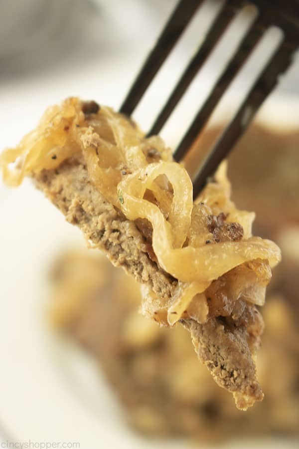 Closeup of liver with onions on a fork.