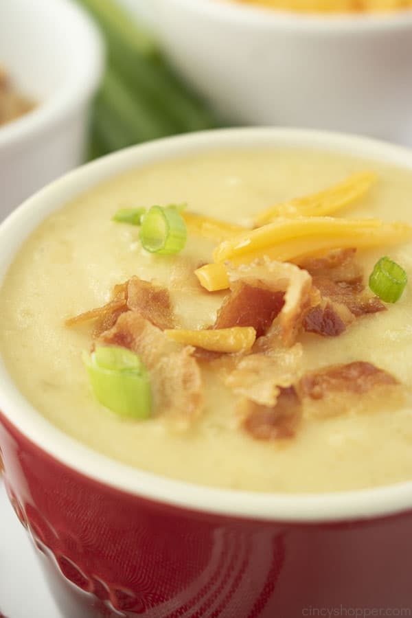 Creamy Potato Soup in a bowl with bacon, cheese and green onion