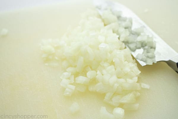 Diced onion on cutting board with knife