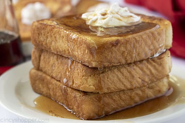 Stack of French Toast on a plate with butter and syrup