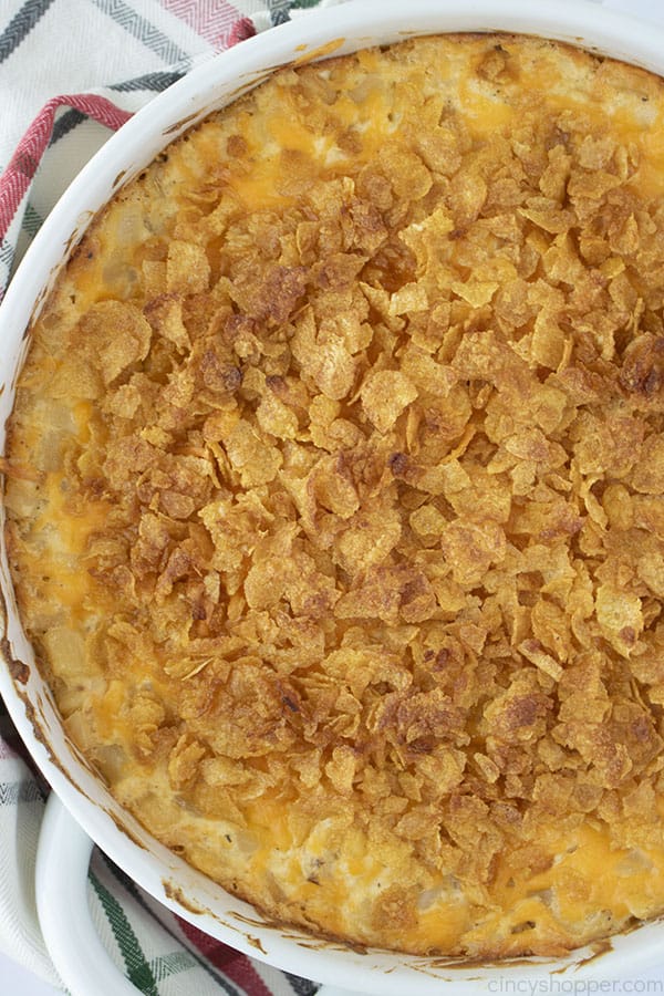 Funeral Potatoes in a white round casserole dish