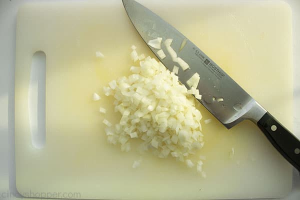 Diced onions on a cutting board with knife