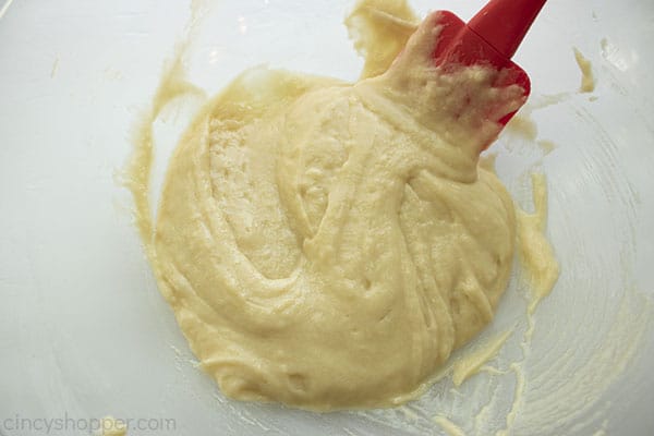 Donut batter in a clear bowl with spatula