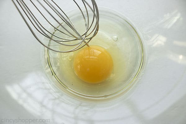 Egg being whisked in bowl