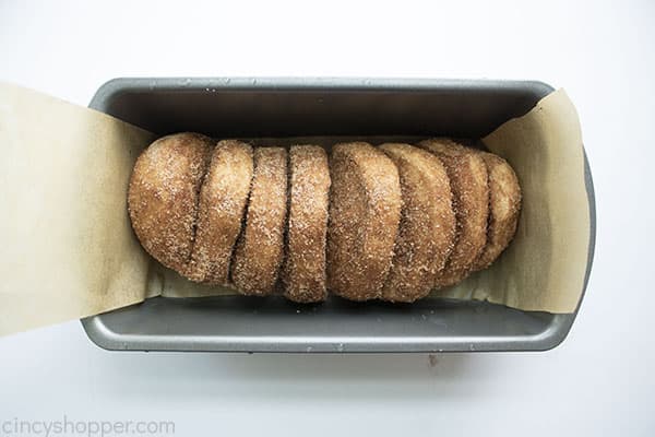 Cinnamon bread in a loaf pan with paper