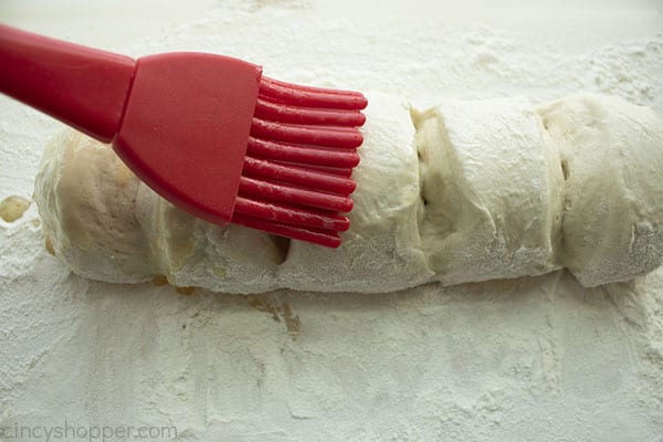 Brushing butter on bread loaf