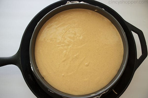 Cheesecake inside of a skillet for water bath