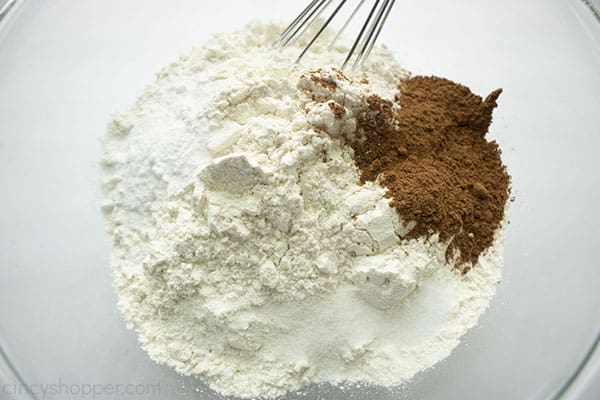 Dry ingredients in a clear bowl with whisk.