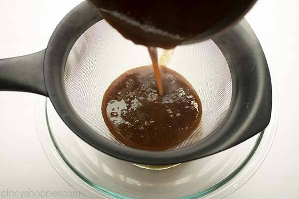 Straining pumpkin spice syrup