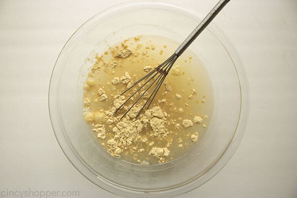 Gravy mixes in bowl with cold water and a whisk