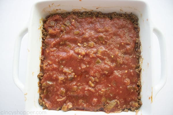 Picante sauce added to the top of ground beef layer