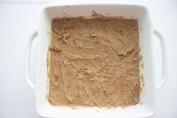 Refried beans in the bottom of baking dish