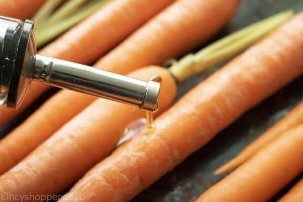 Adding olive oil to carrots