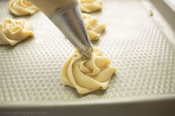 Piping cookie onto cookie sheet
