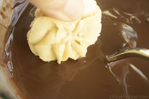Dipping cookie in chocolate