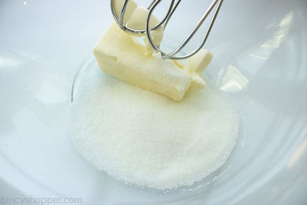 Butter and sugar in a bowl with beaters