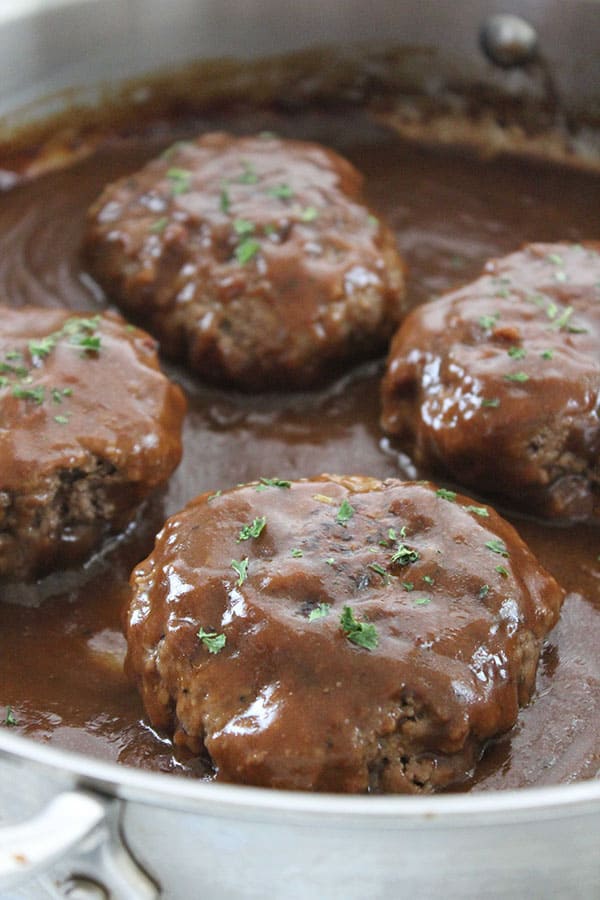 Salisbury Steaks in a pan with gravy