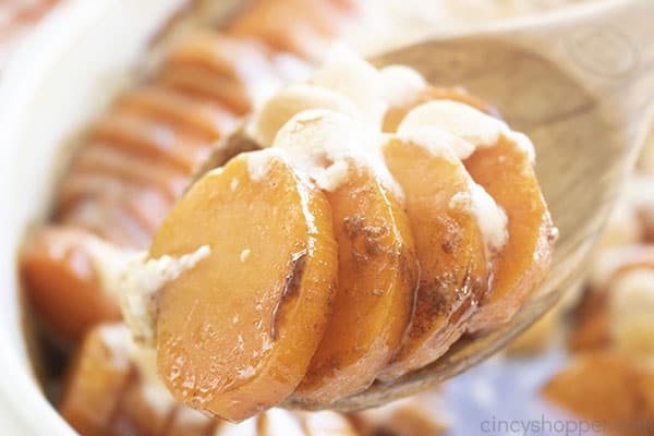 Sliced candied sweet potatoes on a spoon