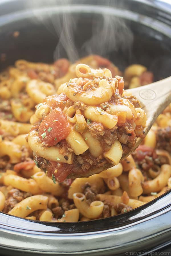 Goulash on a wooden spoon made in slow cooker