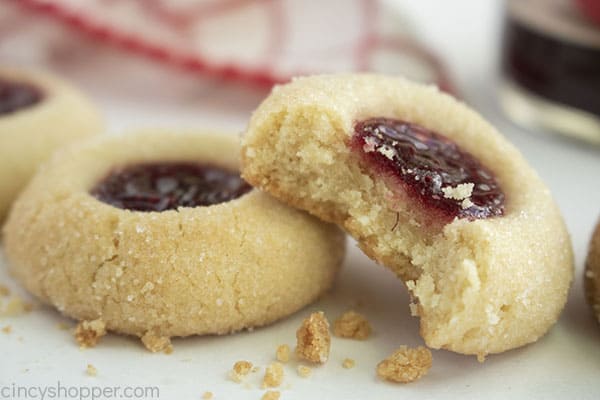 Fresh baked Christmas Jam thumbprint cookies with a bite