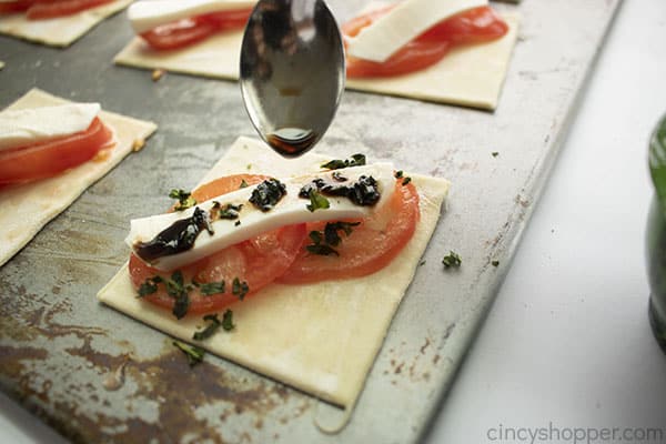 Balsamic vinegar added to top of Caprese bites