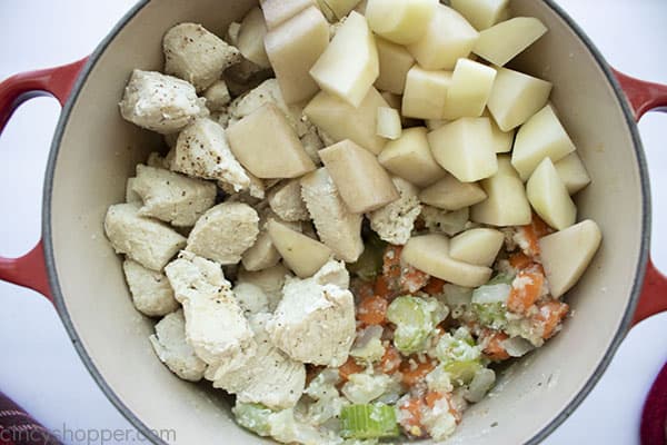 Potatoes and chicken added to pot