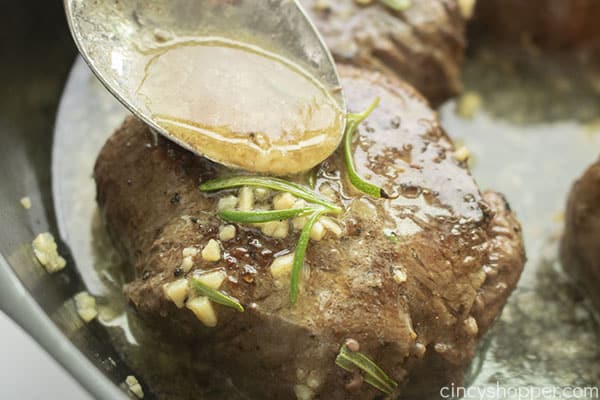 Spoon with garlic butter sauce for steak