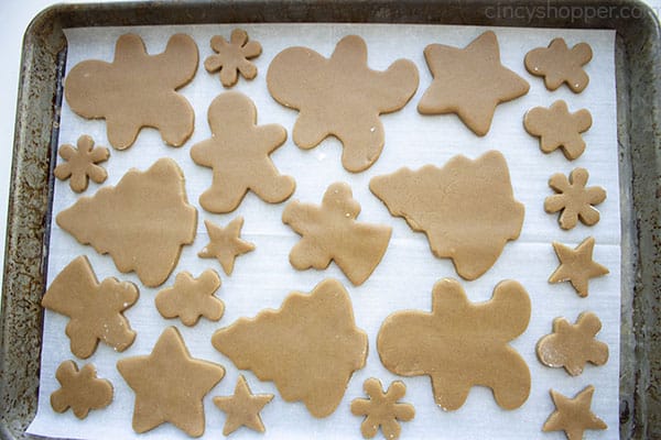 Cutout gingerbread cookies on a cookie sheet