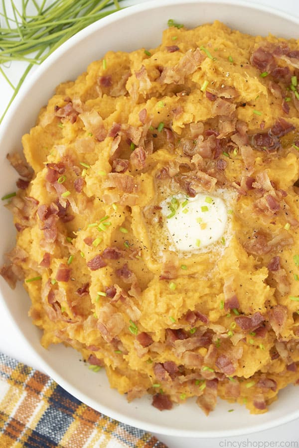 Mashed Sweet Potatoes with Bacon and Chives in a bowl.