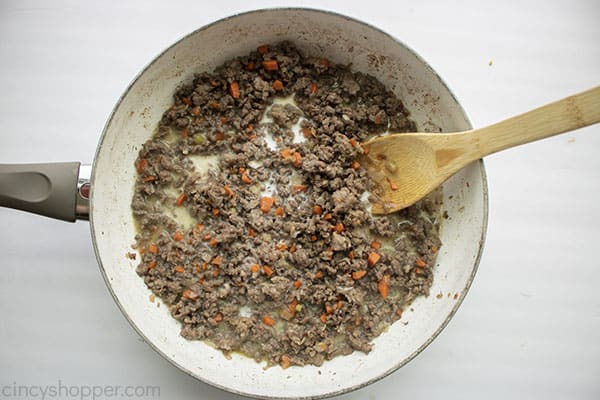 Drained meat and vegetables in a pan