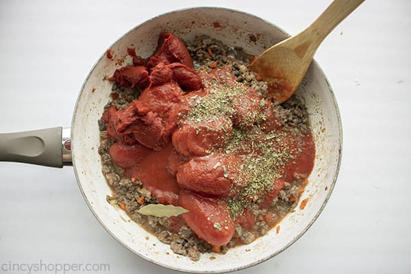 Tomatoes and seasonings added to meat