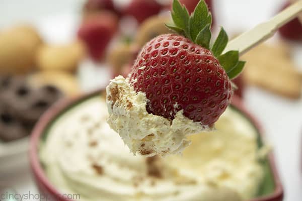 Christmas appetizer eggnog dip on a strawberry