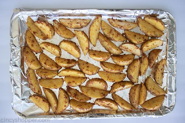 Seasoned potatoes on a foil lined sheet pan