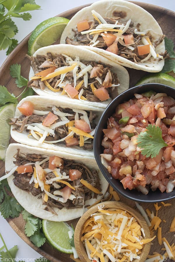 Slow Cooked Barbacoa meat on tacos with toppings