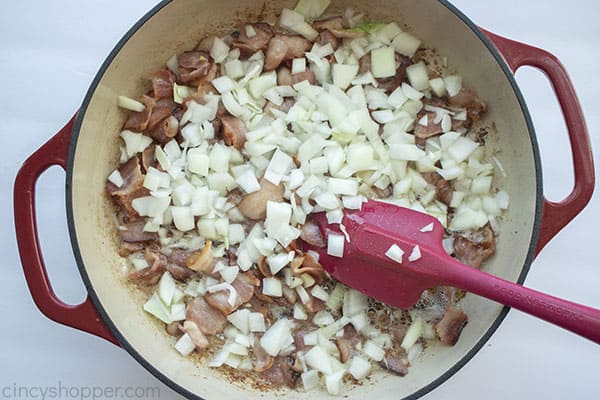 Onions added to bacon in pan