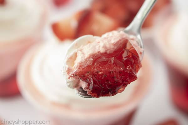 Layered Jello dessert on a spoon