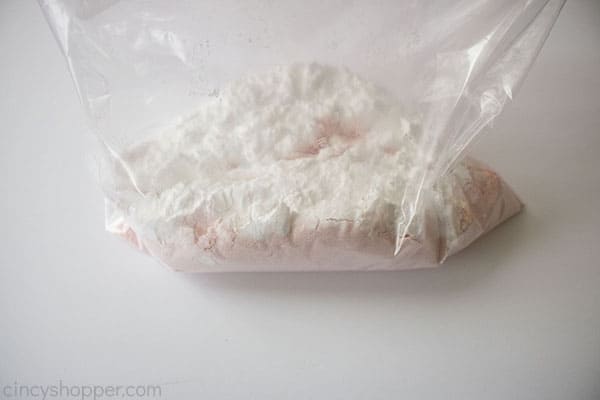 Strawberry cake mix and powdered sugar in a zippered bag