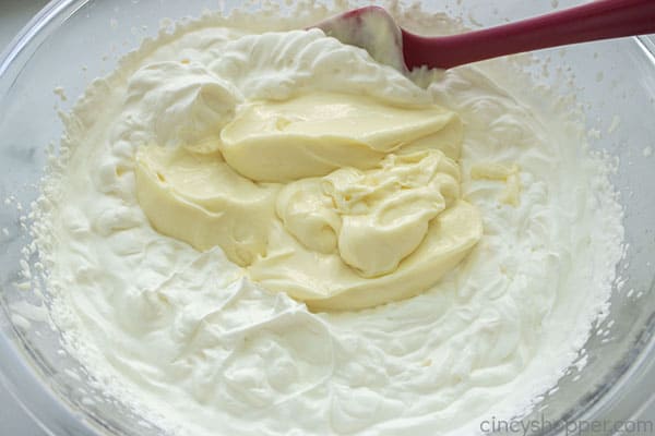 Remaining pudding being folded into whipped cream