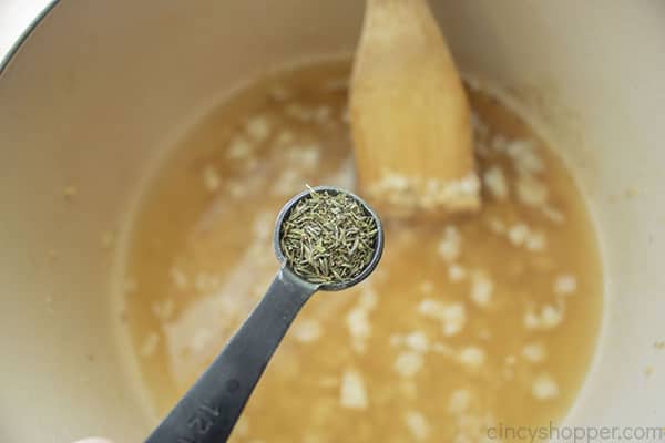 Adding thyme to broth mixture