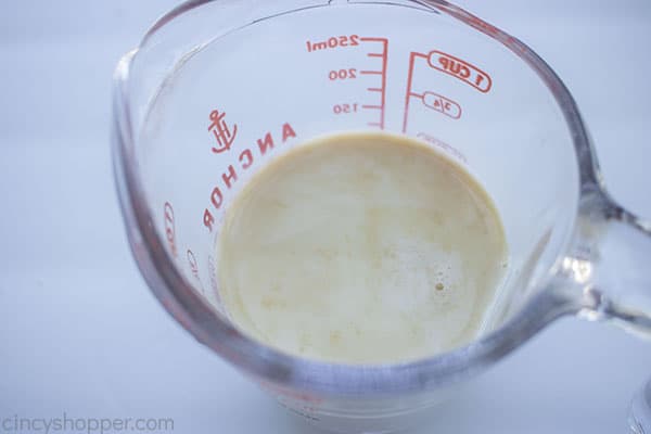 Vanilla added to milk in a measuring cup