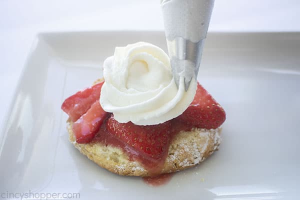 Whipped topping added to strawberries